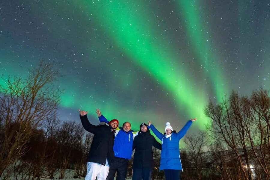 From Tromsø: Aurora Minibus Chase with Portrait and Hot Meal - Suits up in Tromsø: what your 17:45 start feels like