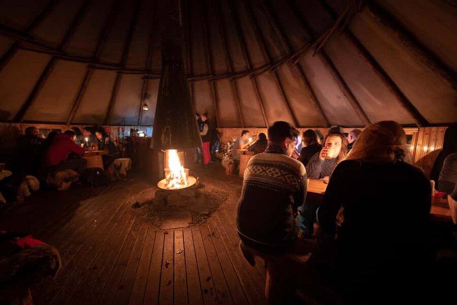 From Tromsø: Northern Lights Visit at Camp Tamok - Warm-up in a Sámi lavvu: stew, fire, and the feeling of place