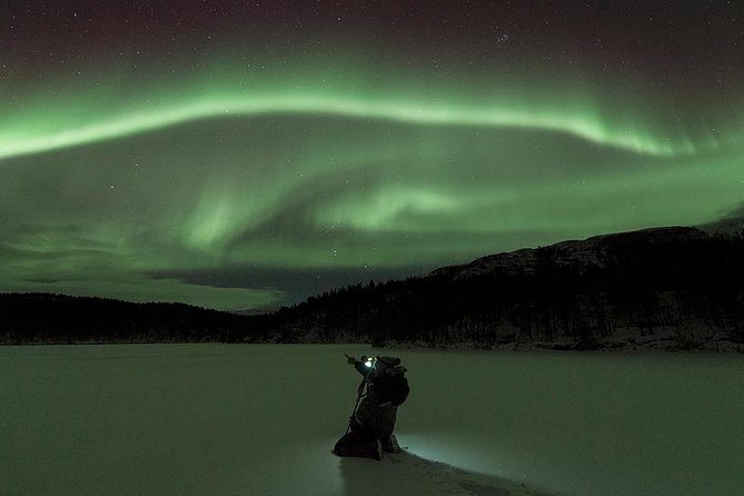 The northern lights over the mountains outside Tromsø
